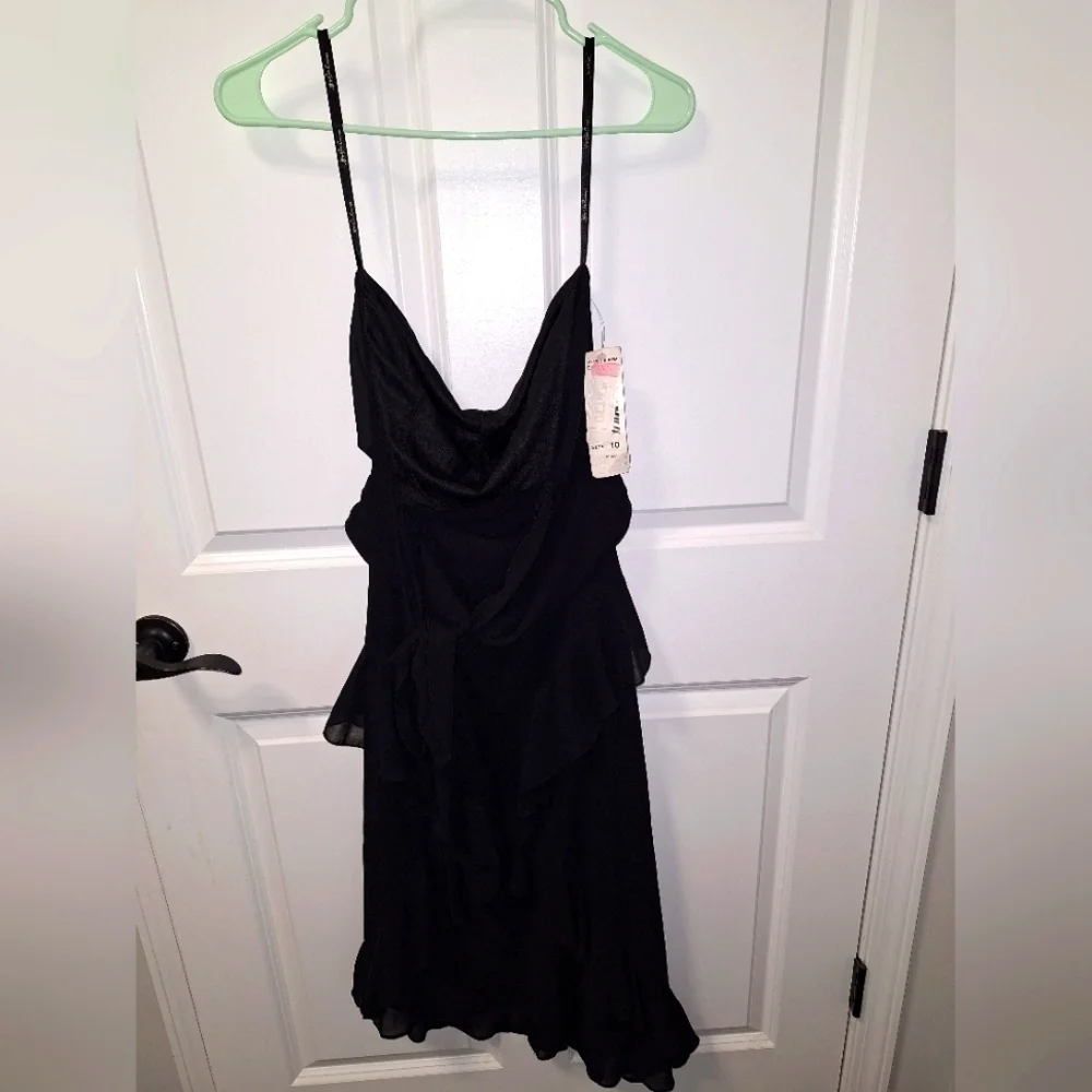A Jeffrey and Dora asymmetrical Tiered black midi dress in a size 10. It's NWT.